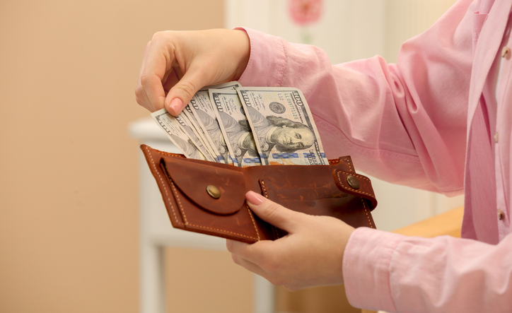 Woman counting dollar bills indoors, closeup with space for text. Money exchange