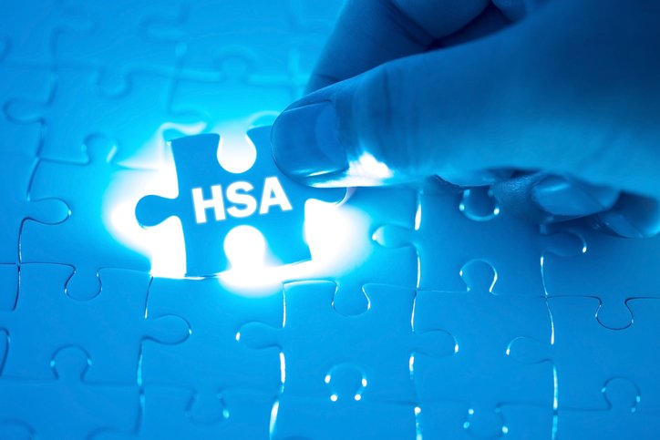 Doctor hand holding a jigsaw puzzle with HSA (Health Savings Account). Medical concept